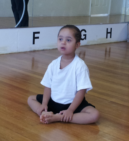 Special needs boy sitting in dance studio